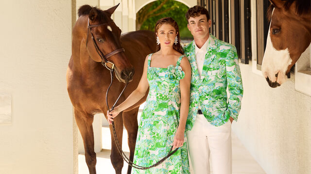 Models wearing formal clothing in horse stable